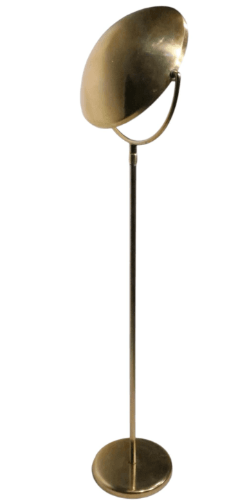 A tall, slender floor lamp constructed entirely from brass, featuring a circular base, a straight stem, and a distinctive dome-shaped shade. The shade appears to be adjustable, mounted on a curved arm that attaches to the main stem. The brass exhibits a polished, reflective finish, suggesting a mid-century modern aesthetic. — 3D model