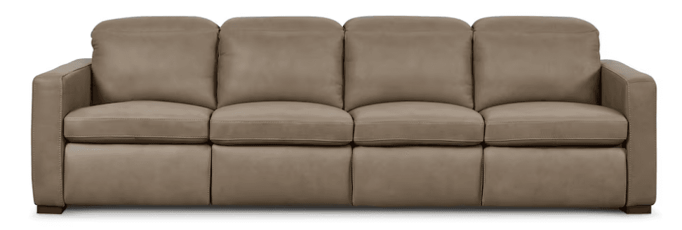 A four-seater sofa with plush cushions and a streamlined design. The sofa features distinct seat cushions and back cushions, with visible stitching along the edges. It has square arms and is supported by short, dark wooden legs. — 3D model