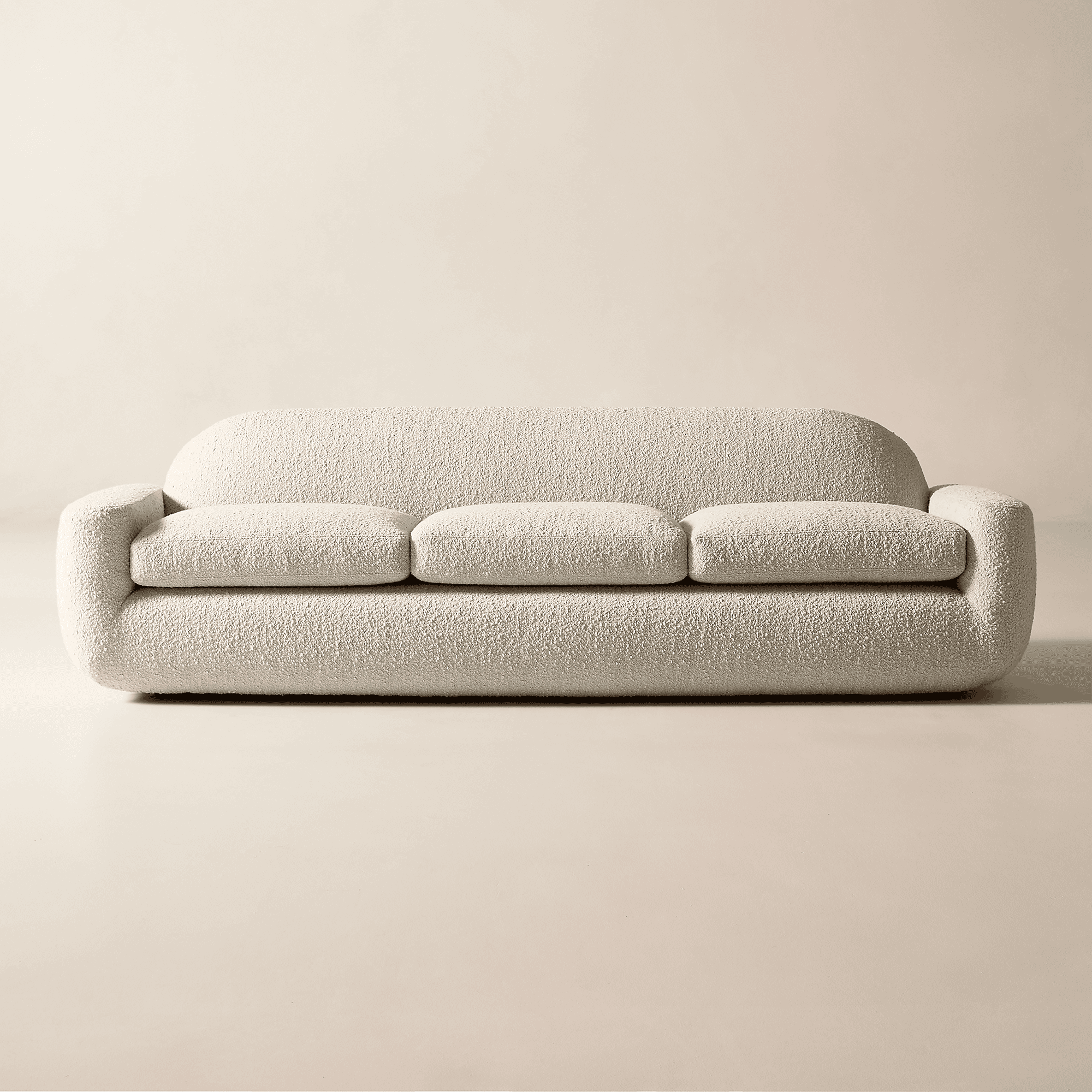 A contemporary three-seater sofa upholstered in an off-white bouclé fabric, featuring a distinctly rounded and plush silhouette with three individual seat cushions. — 3D model