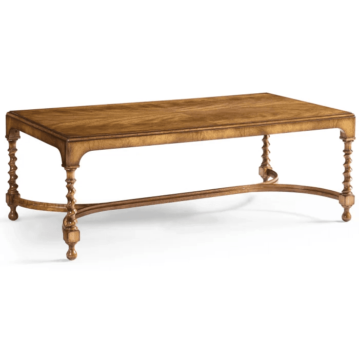 A rectangular coffee table with a wooden top featuring a chevron wood grain pattern. It is supported by four turned legs, two on each side, connected by curved stretchers. The legs have a barley twist design and terminate in block feet. — 3D model