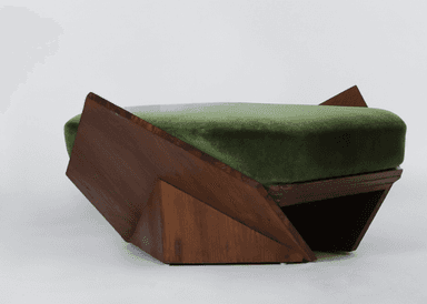 The image shows a contemporary or Art Deco-inspired ottoman with a robust, angular wooden frame, possibly walnut, and a soft, plush green velvet upholstered cushion. The design features geometric facets, giving it a sculptural quality. — 3D model