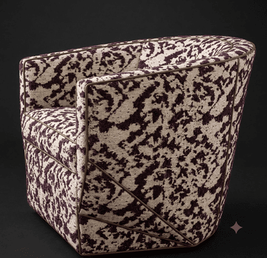 A modern upholstered tub chair featuring a striking abstract patterned fabric in cream and deep purple. It has a rounded, enveloping form with a high back and arms, accented by precise piping. A distinctive external metallic frame in a bronze or brass tone wraps around the sides and back, forming a geometric lattice. The chair sits on a recessed base, giving it a low profile. — 3D model