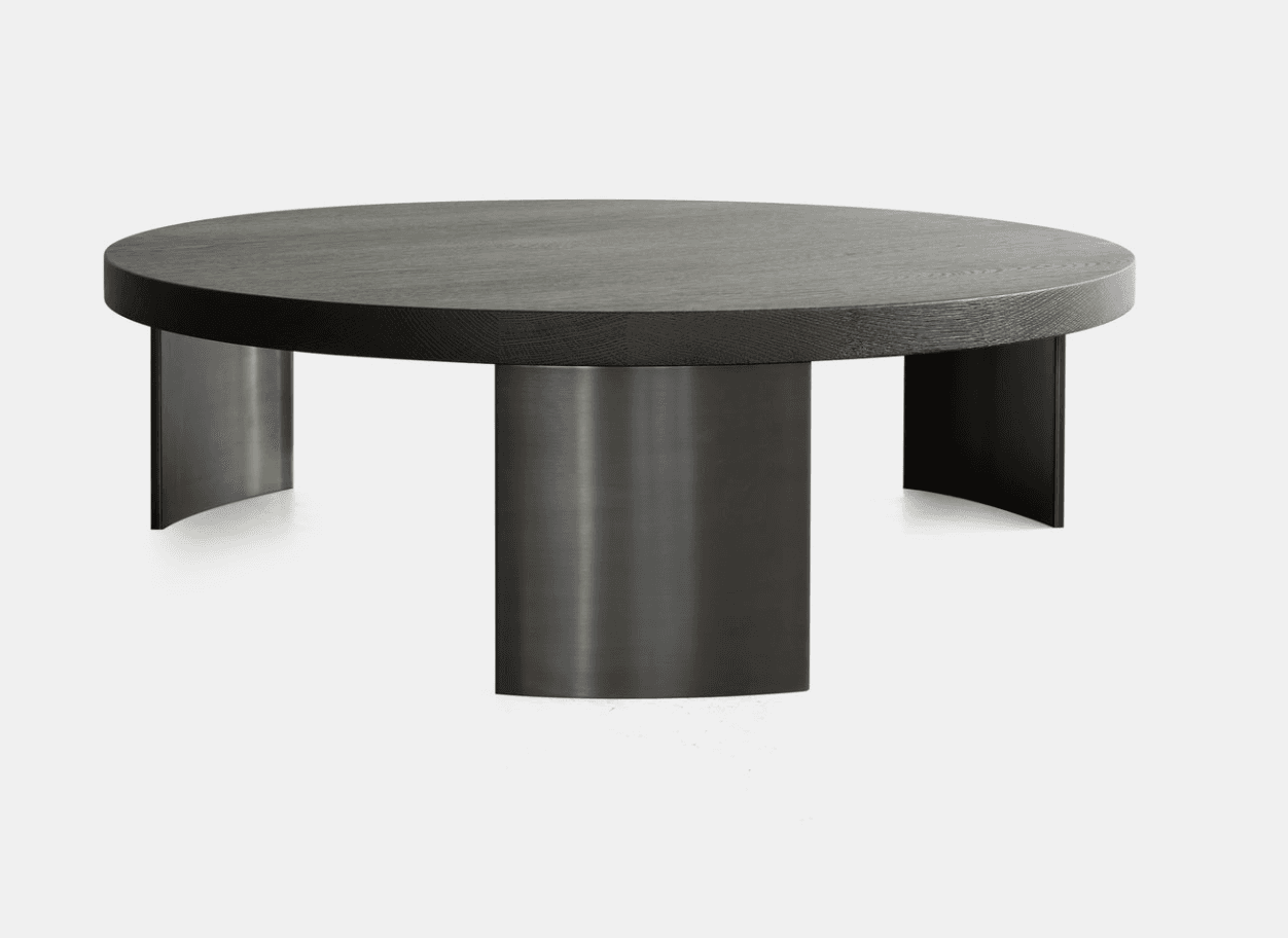 A circular coffee table featuring a dark-stained oak wood top and a multi-pillar base made of brushed metal with a blackened or bronzed finish. — 3D model