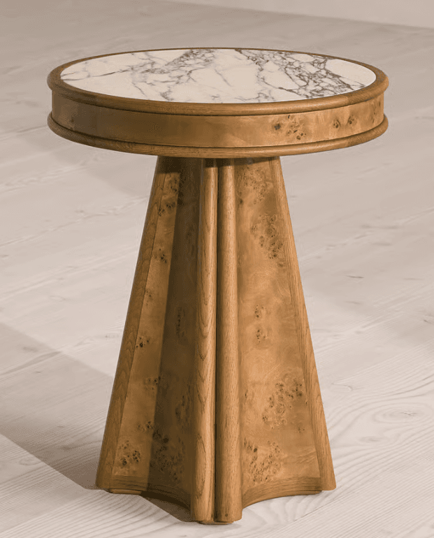 A round end table with a marble top and a wooden base. The top is circular and features a white marble surface with grey veining. The edge of the top is a wooden frame. The base is a single pedestal that flares out towards the bottom, constructed from wood with a burl grain pattern. The base has vertical fluting or grooved details. — 3D model