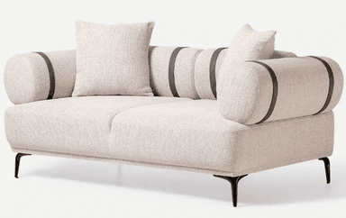 A modern two-seater loveseat featuring light beige textured fabric upholstery. It has distinctive cylindrical bolster arms, which are accented with dark, presumably leather or faux leather, straps. The loveseat includes two square loose throw pillows in the same fabric. It is supported by slender, splayed black metal legs, giving it an elevated and airy appearance. The overall design is clean, minimalist, and contemporary. — 3D model