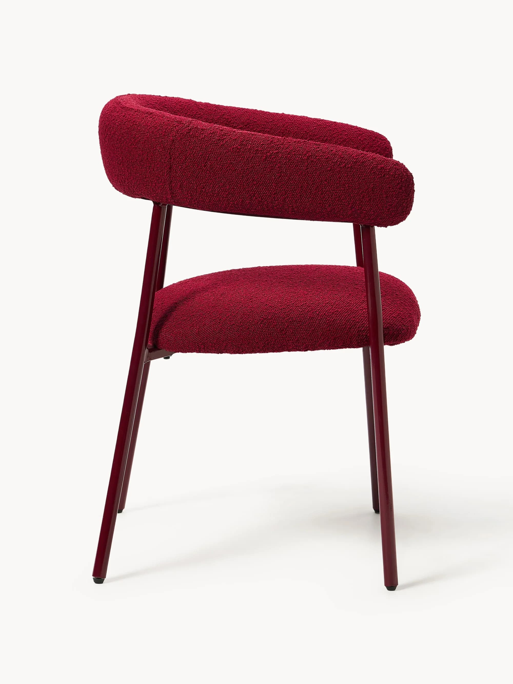 A modern armchair with a curved backrest that extends into armrests. The seat and back are upholstered in a textured, looped fabric. The frame consists of four slender, tapered legs and a support structure for the seat, all finished in a dark red, glossy coating. — 3D model