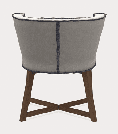 A upholstered armchair viewed from the back. It features a curved backrest with a piped edge in a darker contrasting color. The seat and back are covered in a light gray fabric with visible stitching details along the seams and edges. The chair is supported by four wooden legs, with two front legs and two back legs that are slightly angled, connected by an X-shaped stretcher. — 3D model