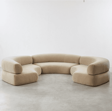 A large, modular sectional sofa with multiple curved sections, upholstered in a light beige velvet fabric, designed for flexible arrangement in a contemporary setting. — 3D model