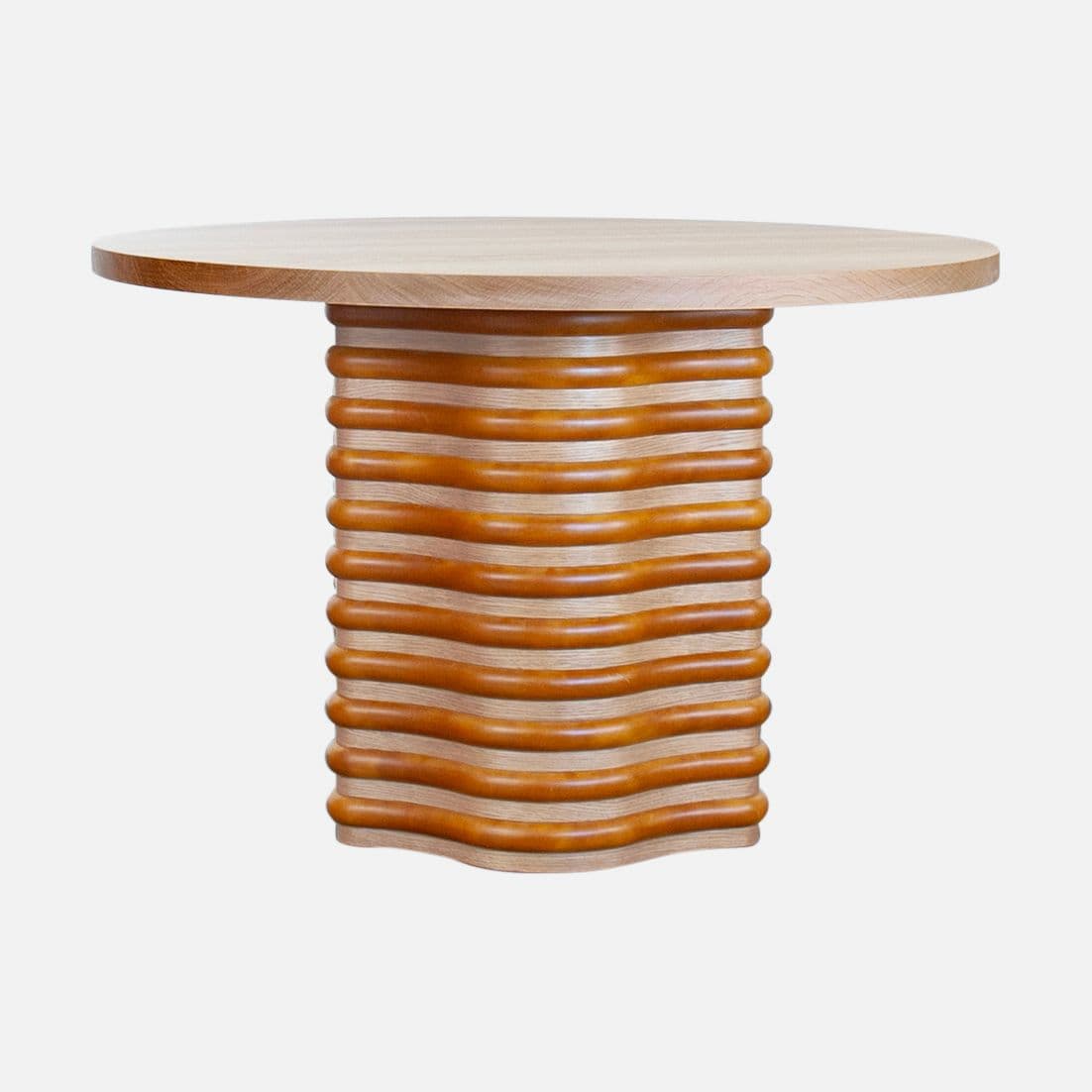 A round-topped end table with a fluted pedestal base. The pedestal is constructed with alternating layers of light-colored wood and curved, darker wood elements, creating a wave-like visual effect. — 3D model