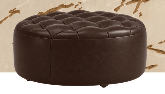A dark brown round ottoman featuring a deeply tufted top surface and smooth, upholstered sides. The tufting is evenly spaced, creating a classic, luxurious diamond pattern. The continuous side panel is seamless, contributing to its refined and substantial appearance. This piece is presented against a plain white background, highlighting its form and texture. — 3D model