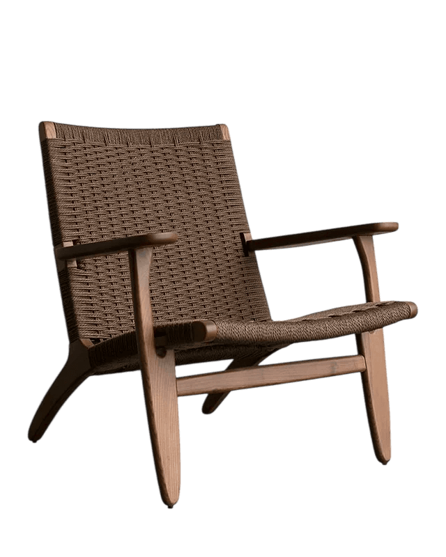 A contemporary armchair with a woven seat and backrest, supported by a wooden frame. The chair features a low profile, angled legs, and integrated armrests. — 3D model