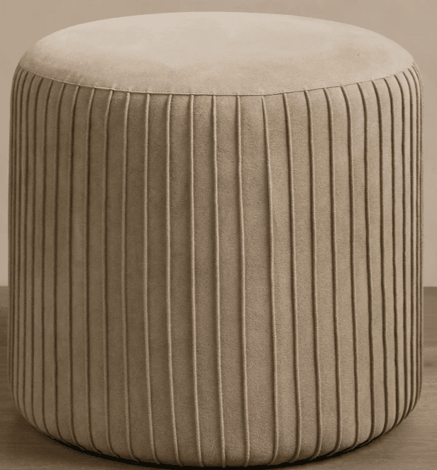 A contemporary cylindrical ottoman featuring a fully upholstered design with a smooth, rounded top surface and vertically fluted sides. The piece is rendered in a neutral beige or taupe fabric, presenting a clean and versatile aesthetic. — 3D model