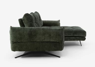 A modern sectional sofa upholstered in a textured dark green fabric. The sofa features deep tufting on the back cushions and seat cushions, creating a grid pattern. It has a chaise lounge on the right side and is supported by slender black metal legs with a distinctive angled design on the left, and a single sculptural metal base on the right. The armrests are wide and rounded. — 3D model