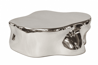 A low-profile, irregularly shaped coffee table with an organic, fluid form and a highly polished, reflective metallic finish. The design mimics molten metal or a naturally eroded stone, rendered in a sleek, contemporary material. — 3D model