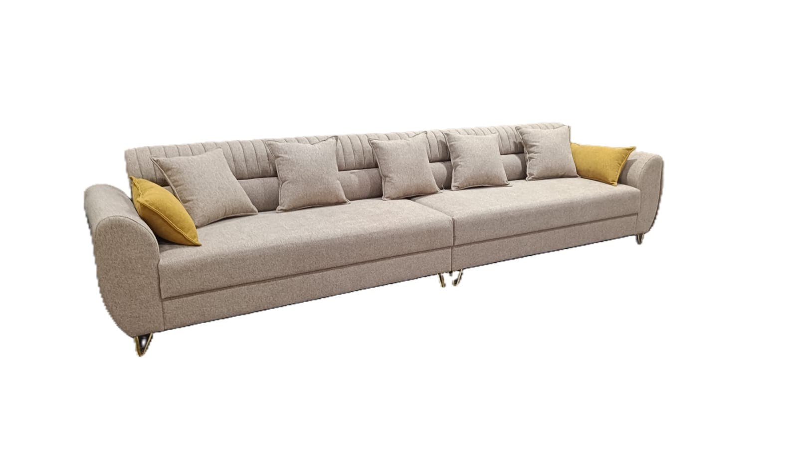 An expansive, light beige modular sectional sofa featuring multiple connected sections, channel-tufted backrests, and rounded armrests. It includes several loose back cushions, seat cushions, and mustard yellow accent pillows, supported by slender, angled metal legs. — 3D model