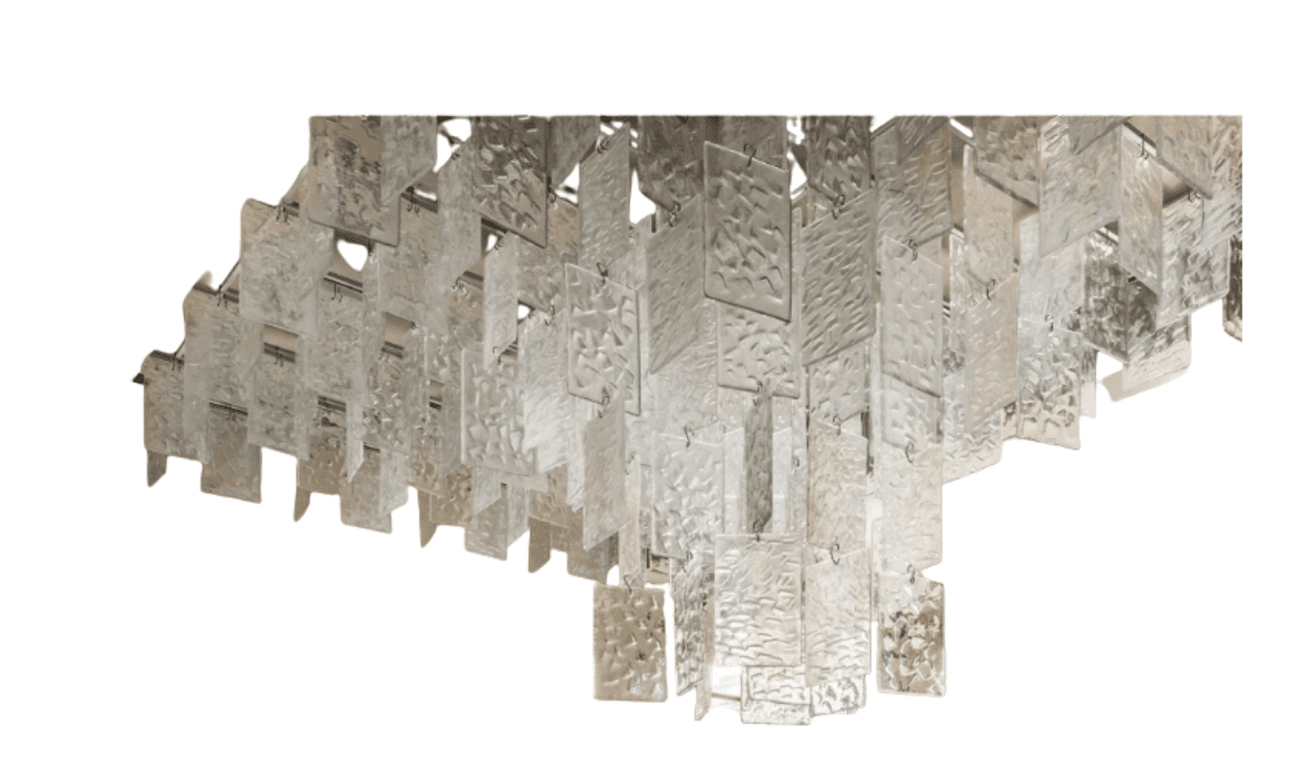 A multi-tiered chandelier featuring numerous rectangular glass panels. The glass appears to be textured or rippled, with a frosted or opaque finish in some areas and clear in others. The panels are suspended in a staggered arrangement from a metallic frame, creating a cascading effect. The overall impression is of a decorative lighting fixture designed to distribute ambient light. — 3D model
