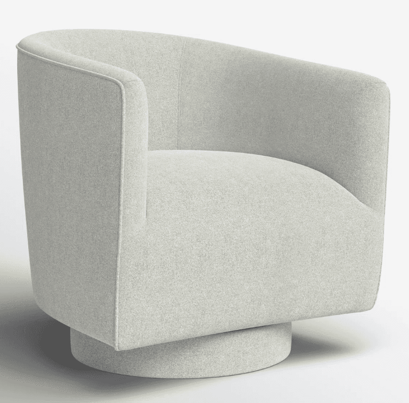 A modern armchair with a swivel base. The chair features a rounded, enveloping silhouette with upholstered arms and back. It is supported by a circular, low-profile swivel base. — 3D model