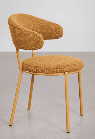 A modern accent chair with a rounded backrest that extends into armrests. The seat and backrest are upholstered in a textured, boucle-like fabric. The chair is supported by four slender, tapered metal legs finished in a mustard yellow color. — 3D model