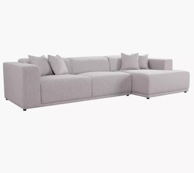 A modern, upholstered sectional sofa with a chaise lounge. The sofa features a low profile, clean lines, and plush cushioning. It is configured with an L-shape, with the chaise extending from one side. Several throw pillows are placed on the seat and backrest. — 3D model