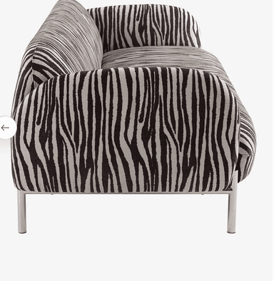 A contemporary loveseat featuring a bold zebra print upholstery. The piece has a low profile with clean lines and is supported by slender metal legs. The design combines a striking visual pattern with a minimalist frame, creating a statement piece for modern interiors. The fabric appears to be a woven textile, offering durability and texture. — 3D model
