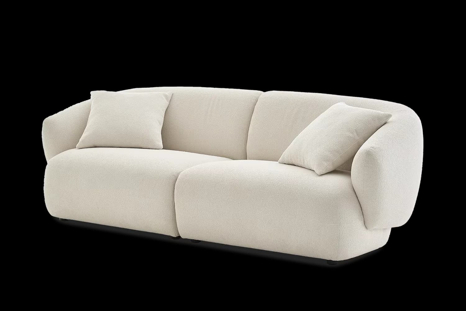 A contemporary two-seater sofa featuring soft, rounded lines and upholstered in a textured cream boucle fabric. It includes two integrated back cushions and two loose throw pillows, maintaining a low-profile aesthetic. — 3D model