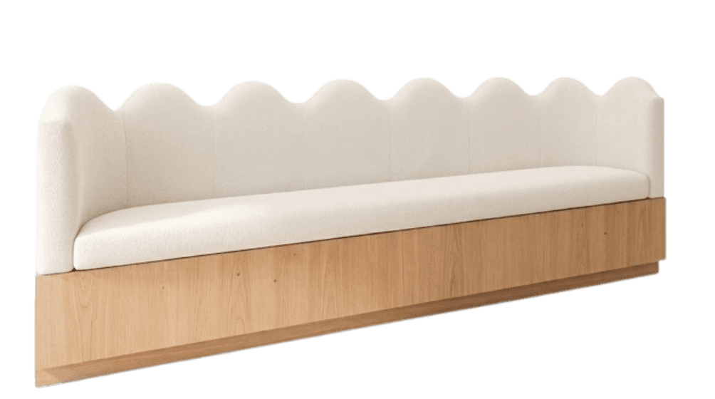 A modern banquette featuring a distinctive scalloped or wavy upholstered backrest atop a solid wood plinth base. The seating and backrest are covered in a light-colored, textured boucle fabric, contrasting with the smooth, light-toned wood base. — 3D model