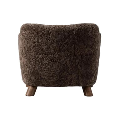 A barrel-shaped ottoman upholstered in dark brown, curly sheepskin or a high-pile faux sheepskin material, supported by four short, tapered wooden legs. — 3D model