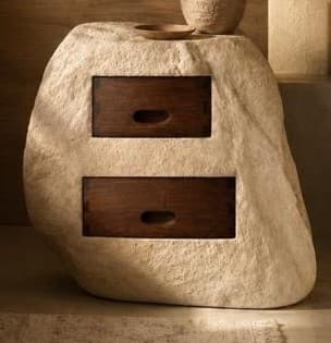 A unique nightstand or small storage unit designed to resemble a natural, light-colored rock or stone formation, with two dark wood drawers seamlessly integrated into its facade. The drawers feature subtle recessed pull handles. — 3D model