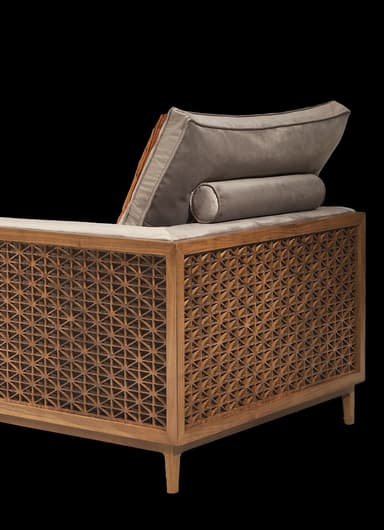 A modular sectional sofa with upholstered cushions and a decorative wooden side panel. The sofa has a low profile with slender wooden legs. It includes several plush throw pillows, one of which has an ornate patterned cover. A matching wooden coffee table with an open compartment is positioned in front of the sofa. — 3D model