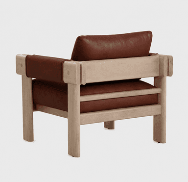 A contemporary armchair featuring a robust wooden frame with squared legs and armrests. The seat and back cushions are upholstered in a rich brown, textured material, likely leather. The armrests have a distinctive design where leather straps wrap around the wooden structure, secured by visible circular fasteners. The wood appears unfinished or lightly treated, showcasing its natural grain. — 3D model
