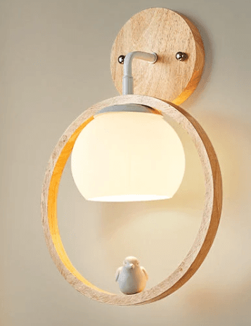 A modern wall-mounted light fixture featuring a circular wooden backplate, a white metal arm, an opal glass globe diffuser, and a larger wooden hoop that frames the globe. A small ceramic bird figurine rests on the bottom of the wooden hoop. — 3D model