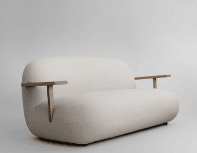 A contemporary two-seater sofa featuring a clean, rounded silhouette, upholstered in a light beige fabric. The design is characterized by its soft, cushioned appearance and distinctive integrated wooden armrests that extend from the backrest. — 3D model