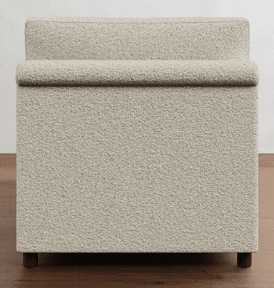 A light-colored sofa bed with a textured fabric upholstery. It features a streamlined design with a low profile, rolled arms on one side, and two distinct back cushions. The front of the sofa shows two pull handles, indicating its function as a sofa bed. — 3D model