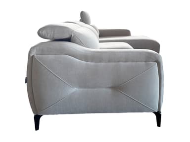 A light gray sectional sofa with a chaise lounge extension. The sofa features plush cushions and a modern design with angular armrests and subtly decorative stitching on the sides. It is supported by slender, dark-colored legs. — 3D model