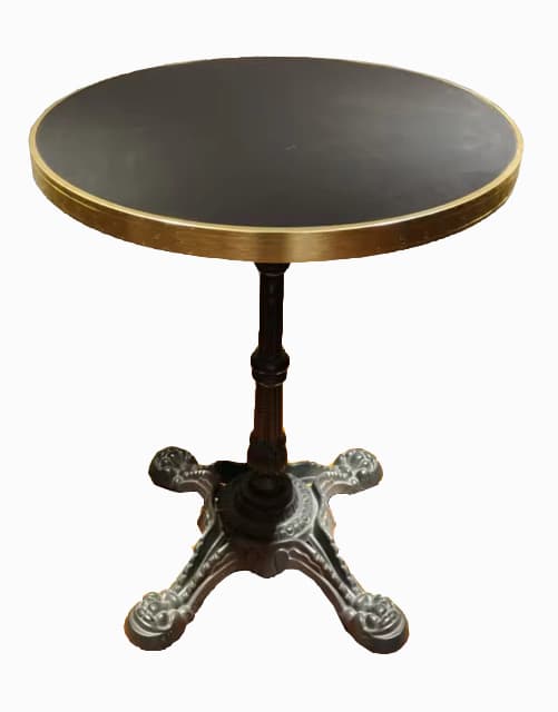 A round side table with a dark-colored tabletop, a brass-colored rim, and an ornate, dark-colored pedestal base with four legs. The base features decorative elements and appears to be made of cast metal. — 3D model