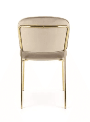 An armless chair featuring a channel-tufted backrest and a padded seat, both upholstered in a light beige velvet-like fabric. The chair stands on four slender, round, gold-toned metal legs. The backrest has a rounded top edge, contributing to a modern and elegant aesthetic. — 3D model