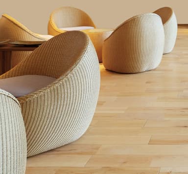 A compact, rounded lounge chair with a tightly woven exterior and a circular, off-white seat cushion, designed for a modern casual aesthetic. — 3D model