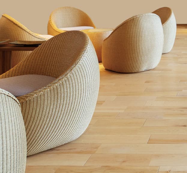 A compact, rounded lounge chair with a tightly woven exterior and a circular, off-white seat cushion, designed for a modern casual aesthetic. — 3D model