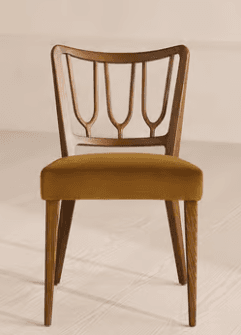 An armless chair featuring a dark brown wooden frame and a mustard yellow upholstered seat. The backrest is crafted from wood with a distinctive open-work design, consisting of several vertical, curved spindles integrated into the frame. The rectangular seat cushion is covered in a soft, velvet-like fabric, and the chair stands on four sturdy, tapered wooden legs. — 3D model