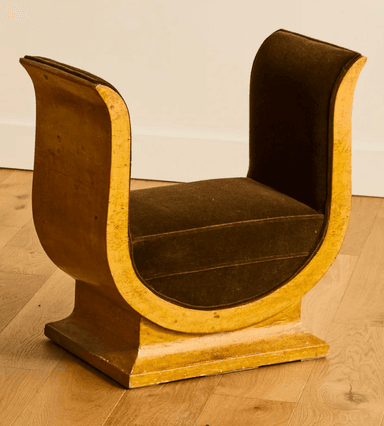 A distinctive bench with a U-shaped frame supporting a cushioned seat. The frame has a glossy, textured finish and appears to be made of wood or a composite material. The seat is upholstered in a dark brown velvet fabric. The overall design suggests a modern or art deco influence. — 3D model