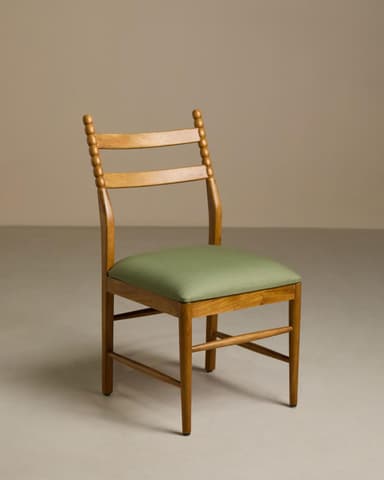 A wooden dining chair with a light natural wood finish and an upholstered green seat cushion. The chair features a backrest with two horizontal slats and vertical back posts adorned with a beaded, turned detail. The legs are straight and connected by simple stretchers, providing stability. — 3D model