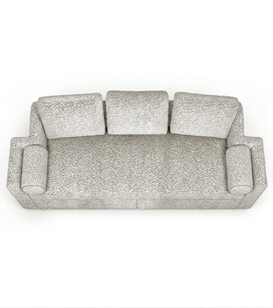 A contemporary three-seater sofa upholstered in a light, neutral-toned, richly textured fabric. It features three loose back cushions, wide integrated armrests, and two cylindrical bolster pillows at each end. The sofa has a low-profile design with a deep, continuous seat cushion. — 3D model