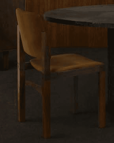 A modern dining chair featuring a minimalist design with a solid wood frame and upholstered seat and backrest. The frame has straight, angular legs and an integrated support structure for the seat and back. The upholstery is a mustard yellow fabric, complementing the warm tones of the natural wood. — 3D model