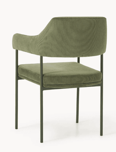 A modern armchair with a gently curved backrest and armrests. The upholstery features a corduroy texture. The frame consists of slender, dark green metal legs. — 3D model
