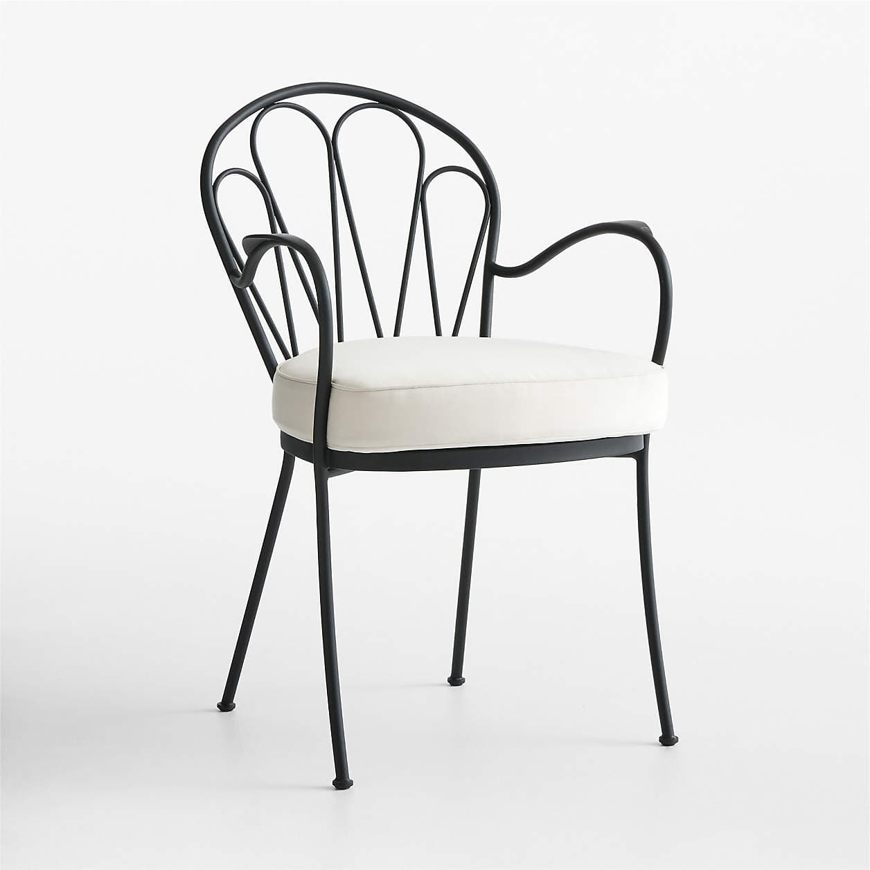 A black metal armchair with a curved backrest featuring a fan-like design formed by vertical metal rods and an overarching curved frame. It has integrated armrests that curve downwards and outwards, and four slender legs. The seat is fitted with a thick, rectangular cushion in a cream or off-white color. — 3D model
