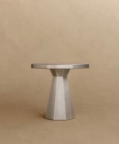 A contemporary octagonal table with a faceted pedestal base, rendered in a uniform grey finish, likely metal or a composite material. — 3D model