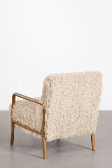 A cream-colored armchair with a textured, fluffy upholstery. The frame and armrests are made of polished wood, featuring a minimalist design with gently curved lines. The chair rests on four wooden legs. — 3D model