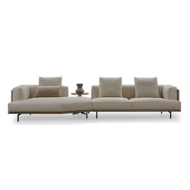 A contemporary modular sectional sofa featuring a chaise lounge section, a two-seater section, and an integrated circular side table. The sofa is upholstered in a textured cream-colored fabric and supported by slender dark metal legs. — 3D model