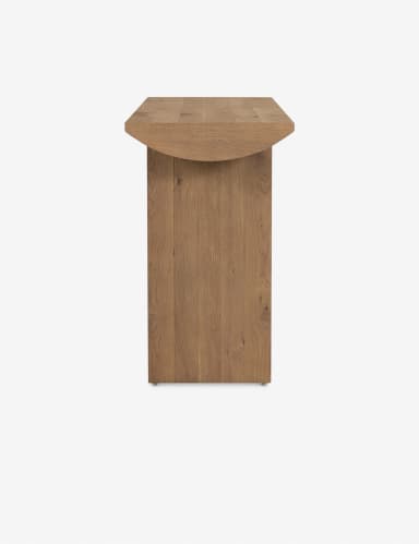 A long, narrow console table with a solid wood top and two block-like legs. The top has a gently curved edge on one side and a flat edge on the other. The legs are rectangular in shape and are positioned at the ends of the table. The wood grain is visible throughout the piece. — 3D model
