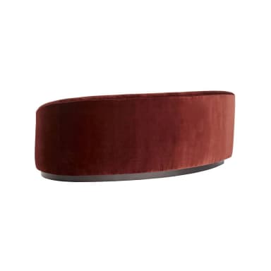 A curved sofa with a plush velvet upholstery in a deep reddish-brown hue. The sofa features a rounded silhouette with integrated armrests and a low-profile base. The base appears to be made of a darker material, possibly wood or metal, with a smooth finish and a slightly curved profile that mirrors the overall shape of the sofa. — 3D model